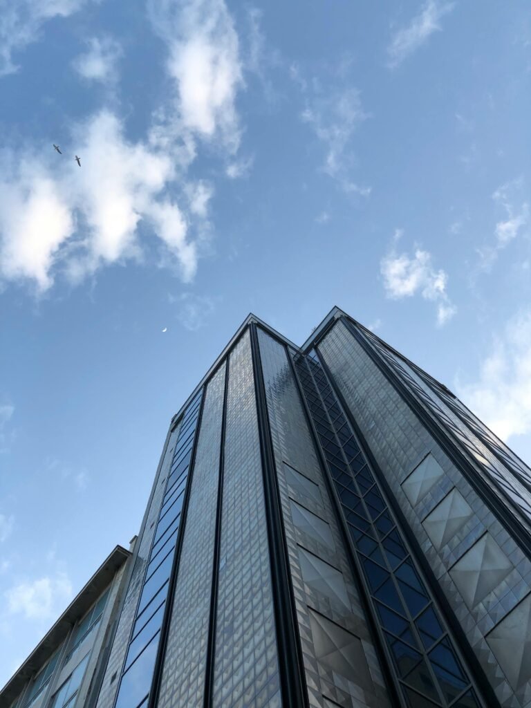 Low angle view of modern skyscraper in Athens under clear blue sky.