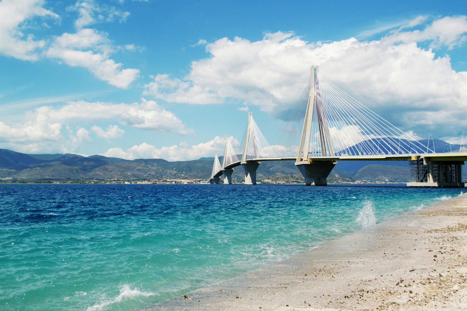 Stunning view of the Patra Bridge over turquoise waters on a summer day.